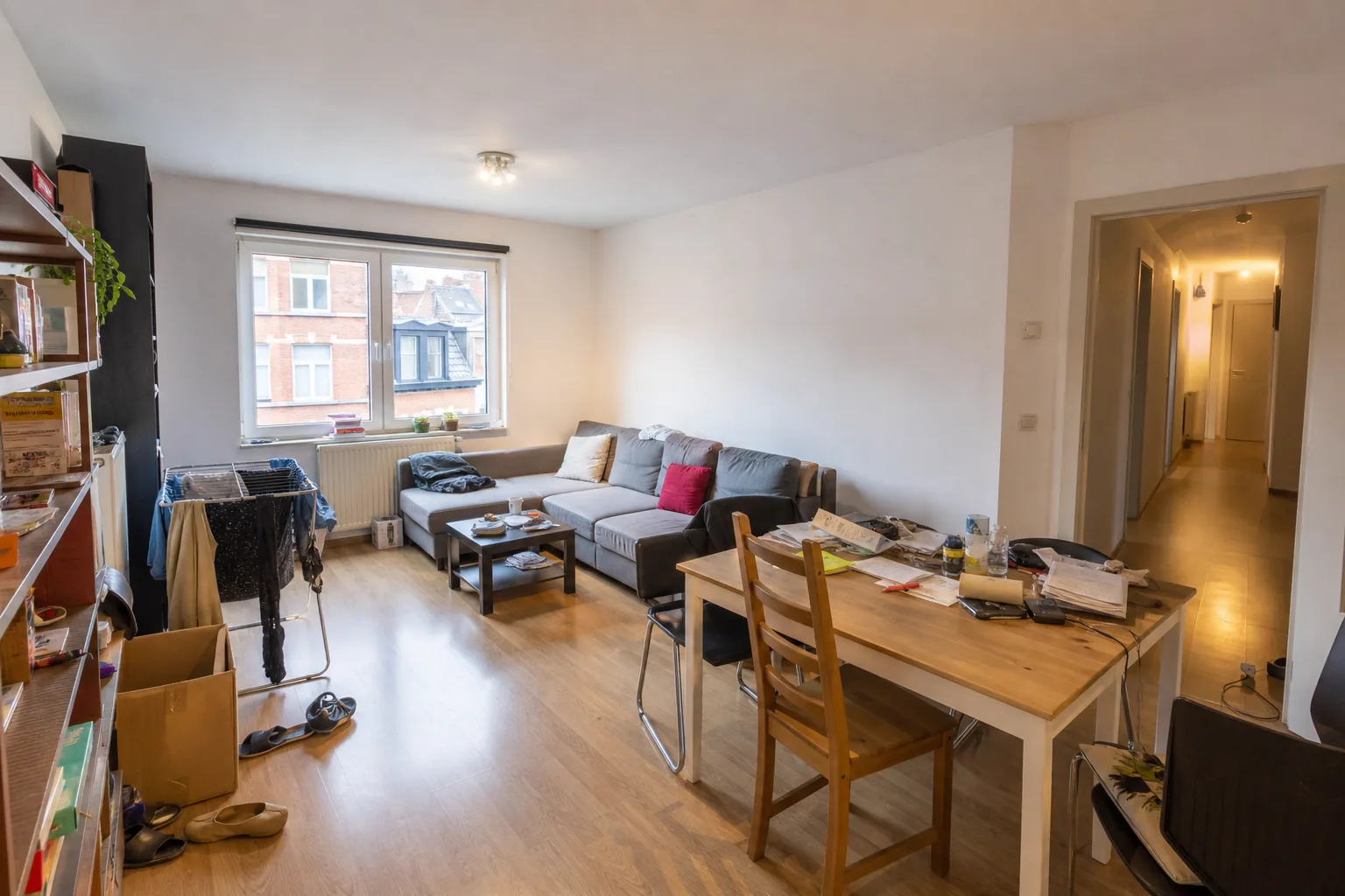 Cluttered living room in an occupied Belgian apartment